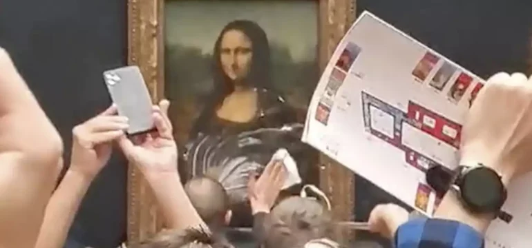 man-disguised-as-woman-in-a-wheelchair-arrested-after-smearing-mona-lisa-with-cake-at-louvre-1531275985248669698