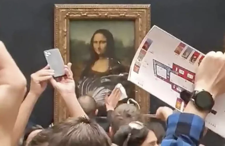 man-disguised-as-woman-in-a-wheelchair-arrested-after-smearing-mona-lisa-with-cake-at-louvre-1531275985248669698